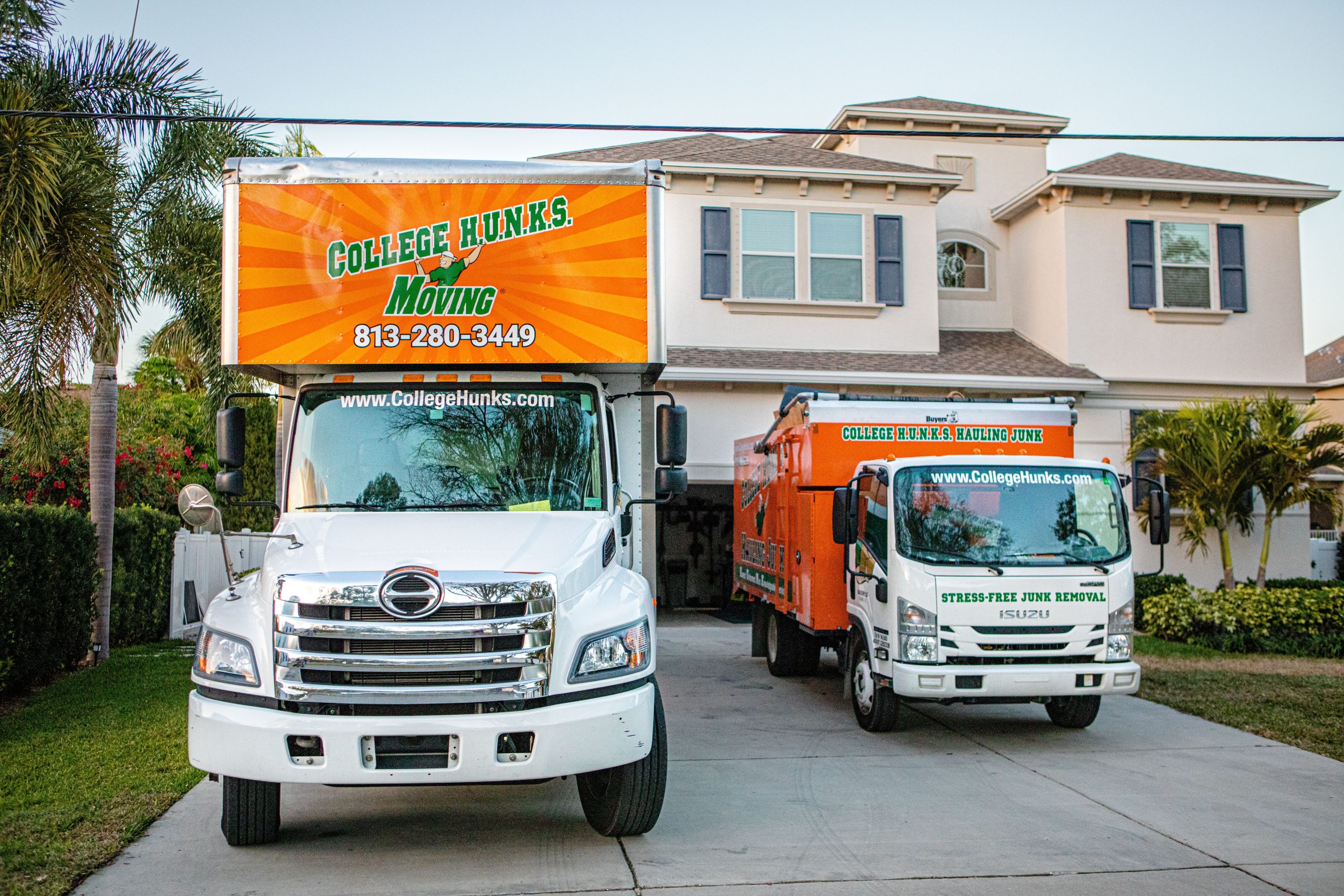 2 junk removal franchise trucks parked in a driveway