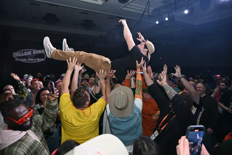 Franchisee crowd-surfing at the College HUNKS reunion celebration