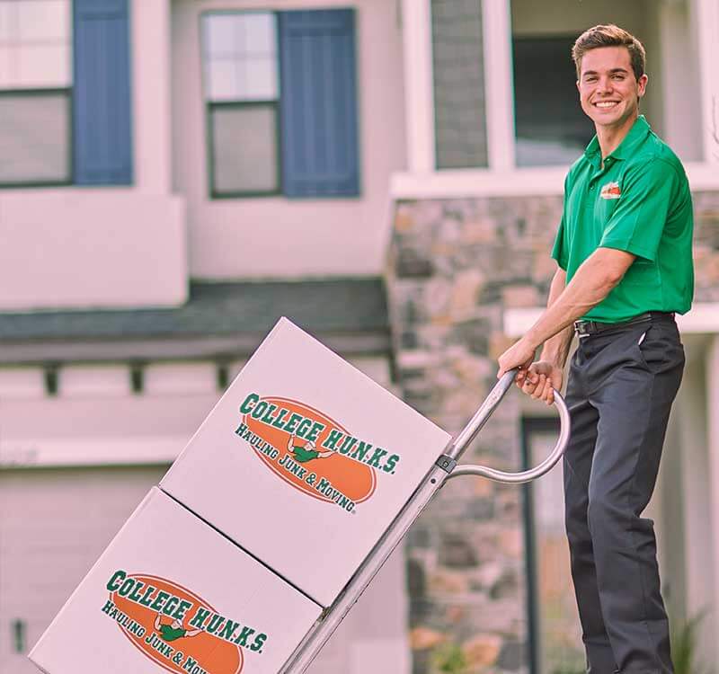 College HUNKS crew loading branded boxes, the local operation behind every franchise ownership structure